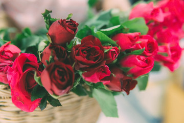 Bouquet of red roses in the wicker basket. Selective Focus. Flower Background.