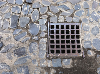 Old iron grate of the drainage system