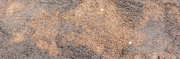 Gray and brown fine gravel stones for the underground for paving stones. Panoramic image