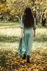 girl runs through the autumn forest
