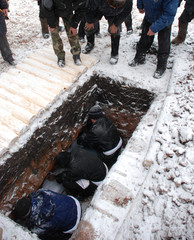 Funeral Bashkir Muslim ceremony. Dug up grave before burial.