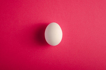 White egg red plain minimal background, top view, happy Easter day