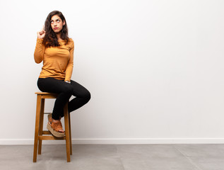 young pretty woman raising palm to forehead thinking oops, after making a stupid mistake or...