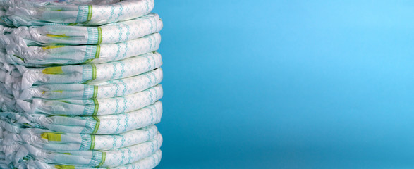 Stack of diapers. Banner. Blue background