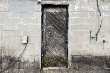 old wood door concrete alley warehouse building abandoned