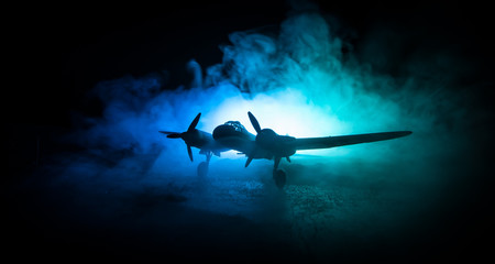 German Junker (Ju-88) night bomber at night. Artwork decoration with scale model of jet-propelled plane in possession.
