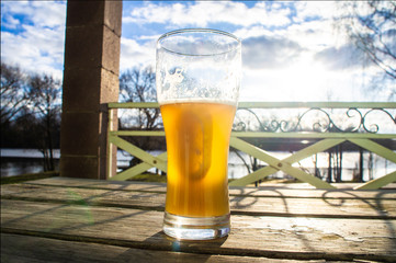 Glass of light beer in the sunlight