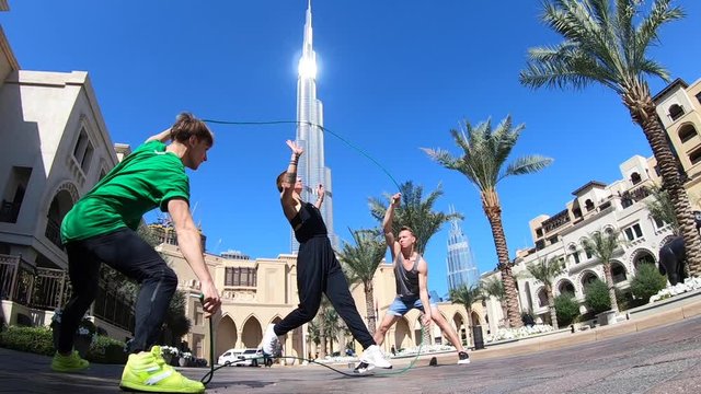 Group of acrobats jumping with double jump rope in Dubai doing different tricks in slow motion