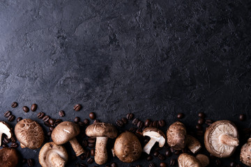 Shiitake mushrooms with coffee beans on a dark background. Top view. Coffee with mushrooms -...