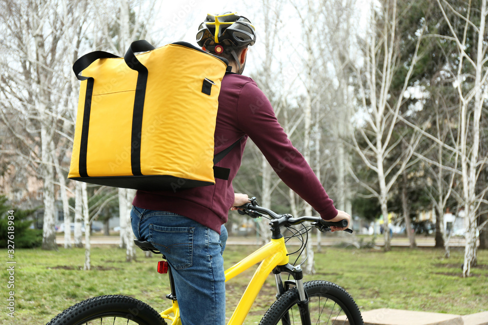 Canvas Prints Courier with thermo bag riding bicycle outdoors. Food delivery service