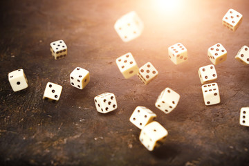 Playing dice fall on table, sun rays.