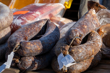 Street food sales from the car. Tray with farm products: sausage, honey, fish, meat.