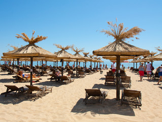 GOLDEN SANDS, BULGARIA - JUNE 02, 2015: people rest on the beach with beach unbrellas.