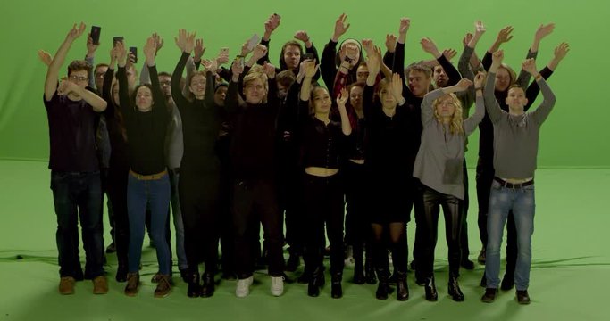 GREEN SCREEN CHROMA KEY Model released, Front view of huge crowd jumping and cheering at a concert or a show. Shot on RED Helium 8K in RAW