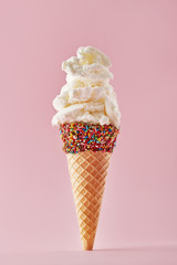 Ice cream cone isolated on a pink background. Copy space
