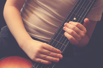 Children's hands and guitar, music training, vintage