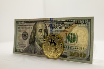 $100 dollar bill with bitcoin cryptocurrency trading and currency exchange