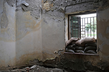 Sandbags piled up at a window of a house in the buffer zone "Green Line" in Nicosia, Cyprus