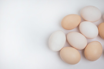 Chicken eggs on the table. Farm products, natural eggs. Copy space for text. Eggs isolated on white background.