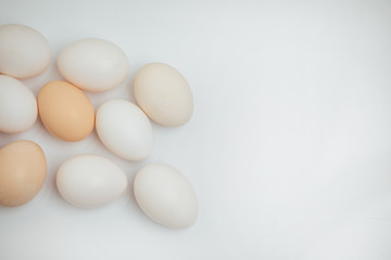 Chicken eggs on the table. Farm products, natural eggs. Copy space for text. Eggs isolated on white background.