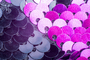Macro round pink and black sequins on the fabric