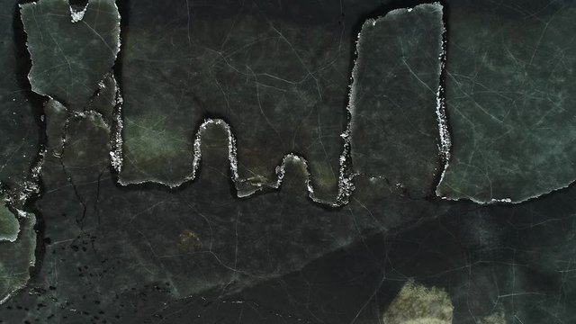 Moving ice plates in spring on lake Burtnieks ice shove aerial view