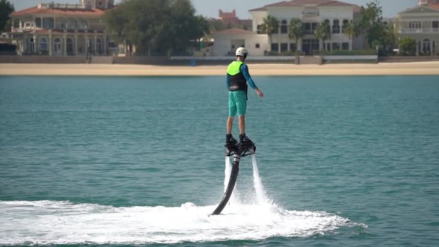 The beginner is learning how to manage at the aquatic flyboard. Extreme rest on the sea