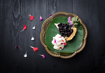Fototapeta na wymiar Piece of blueberry cheesecake on wooden table