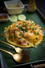 Creamy omelette with shrimp on rice  on wooden table