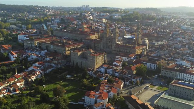 Aerial, drone shot of the city and the Cathedral of Santiago de Compostela, sunny day, in Saint James of Compostella, Galicia, Spain - Pan view