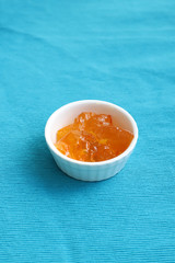 Orange jam or marmalade on bright tablecloth