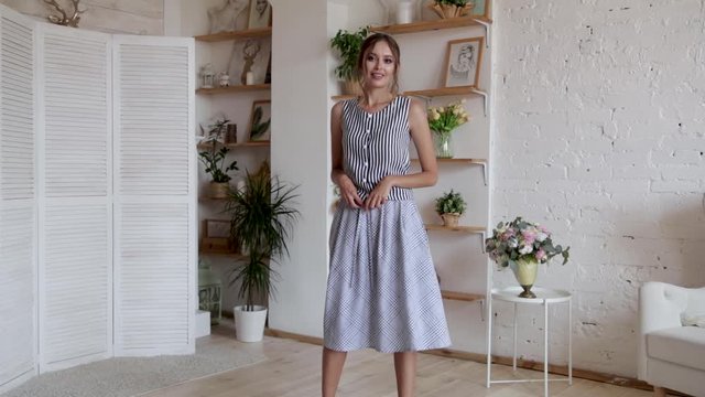 Elegant girl posing in a beautiful dress in her home interior , 50 fps