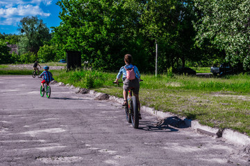 Fototapeta premium children ride a bike in the summer