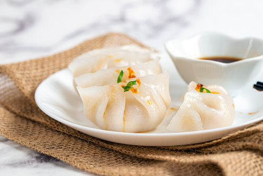 Crystal dumplings with minced pork filing, garnished with green onion and fried shallot