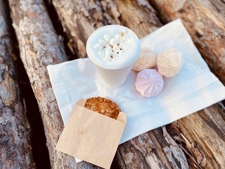 coffee with marshmallow and oat cookie on wood