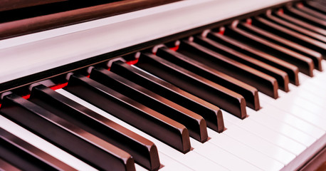 new elegant piano synthesizer with black and white keyboard at bright electric light