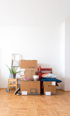 Move. Cardboard boxes, cleaning things and stuff for moving into a new, clean and bright home. Text space.