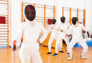 sporty young woman in mask with foil