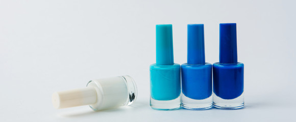 colored nail polishes on a white background