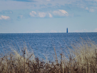 ocean with lighthouse in distance