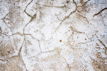 A old wall with cracks for background.Composition with concrete cement wall with crack in industrial building, Will be good for your design and texture background