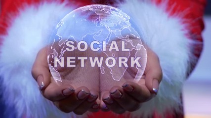 Female hands holding a conceptual hologram of planet Earth with text Social network. Woman in red clothes with faux white fur with future holographic technology - Powered by Adobe