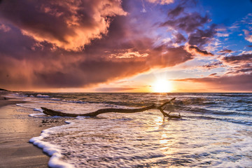 Beautiful cloud cover over the sea sunset at the beach - dramatic sunset on the baltic sea