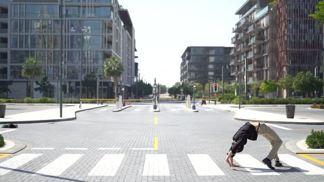 flexible rubber man wearing as Businessman crossing crosswalk upside down as a spider. Concept of creative, innovation.