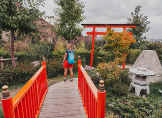 Tourist girl admires Japanese gardens in National Botanical Garden of Tbilisi