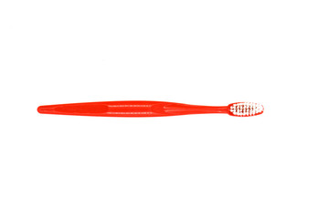 red toothbrush on a white background