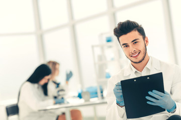 young virologist scientist against the background of a modern laboratory
