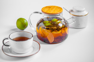fruit tea in a transparent teapot. breakfast
