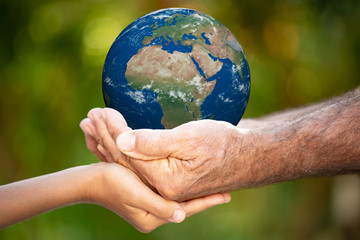 Family holding Earth planet in hands