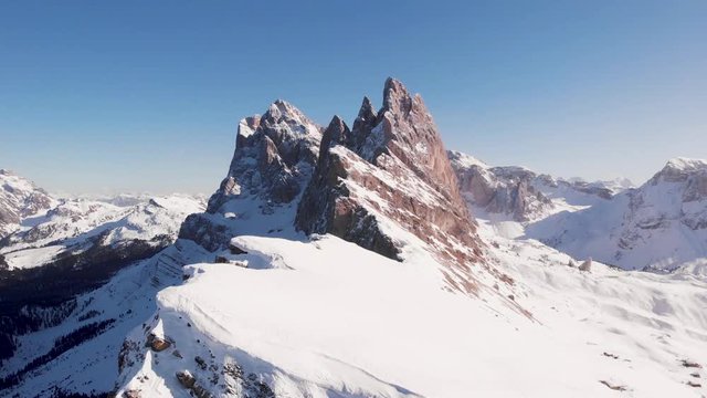 Dolomites mountain peak on a winter sunny day, aerial